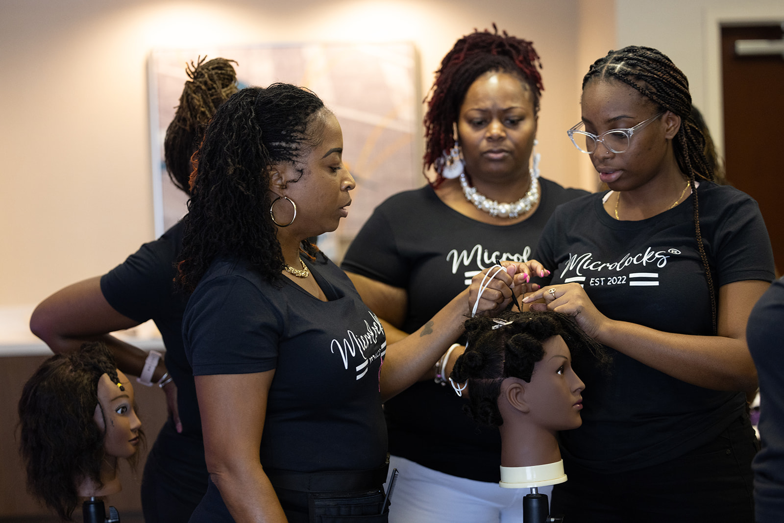 Students practicing MicroLocks techniques on mannequin heads